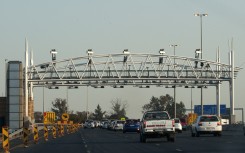 File: South African motorists drive towards the electronic toll plaza on the highway from Pretoria to Johannesburg. ALEXANDER JOE / AFP