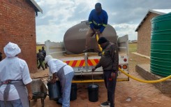 File: Water tankers supplying water to residents. eNCA
