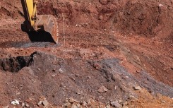 File: An excavator loads a truck at a previously operational gold mine being rehabilitated in the Johannesburg CBD on April 14, 2022. EMMANUEL CROSET / AFP