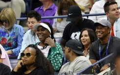 Super fan: Tiger Woods (right) watches the match with Venus Williams