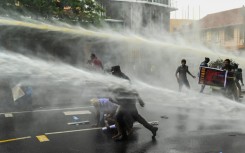 Police use water cannon to disperse demonstrators in Colombo on Tuesday