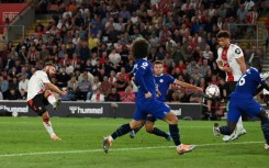 Southampton's Adam Armstrong (L) scores against Chelsea