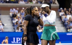 Serena Williams (left) and Venus Williams were beaten in the opening round of the women's doubles at the US Open on Thursday