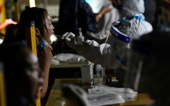 Long lines of residents queued for mandatory testing, while videos verified by AFP showed supermarket shelves cleared of produce