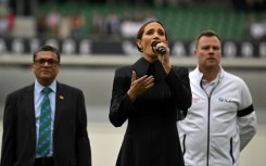 Laura Wright (C) sings ' God Save the King' at the Oval on Saturday