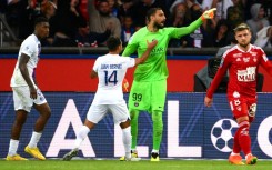 PSG goalkeeper Gianluigi Donnarumma celebrates with Juan Bernat after saving Islam Slimani's penalty against Brest 