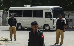 An England team bus drives past security in Karachi after their arrival for their first tour in 17 years