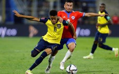 Ecuador's Byron Castillo (L) holds off Chile's Jean Meneses in a qualifying match in Santiago in 2021. Ecuador won, 2-0. Chile complained that Castillo was not Ecuadorean