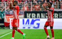 Union Berlin's American forward Jordan Siebatcheu (L) celebrates his goal