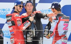Enea Bastianini (right), Francesco Bagnaia (left) and Aleix Espargaro celebrate on the podium at Aragon