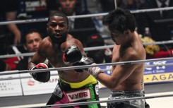 Floyd Mayweather (left) throws a punch at Japan's Mikuru Asakura during their exhibition fight in Saitama, Japan, on Sunday