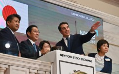 Japanese Prime Minister Fumio Kishida (2-L)  stands with John Tuttle (R), Vice Chairman of the NYSE Group, before ringing the closing bell at the New York Stock Exchange on September 22, 2022