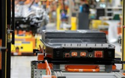 A battery waits to be installed on the frame of an electric-powered F-150 Lightning truck