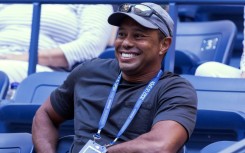 Tiger Woods, shown watching the US Open tennis tournament, is offering advice from afar to US Presidents Cup captain Davis Love as his recovery from severe leg injuries will not allow him to attend at Quail Hollow