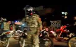 Iranians wave the national flag as they march during a pro-hijab rally in the capital Tehran on September 23, 2022
