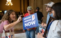 An abortion rights protester shouts at a group of anti-abortion activists in Indianapolis on July 25, 2022 