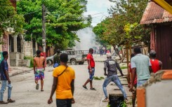 Haitians throw stones at the police during a violent demonstration in August 2022; they were protesting the rising cost of living and insecurity as the country, the poorest in the Western hemisphere, is mired in gang violence and political turmoil