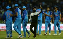 Unwanted intrusion: A pitch invader takes a selfie with India players 