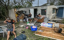 Residents of mobile homes clean up debris in the aftermath of Hurricane Ian, in Fort Myers, Florida, on September 29, 2022