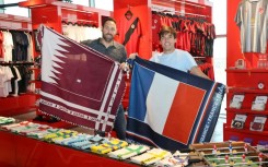 Bertrand Roine and Didier Grande are pictured with fan scarves they designed in the national colours of teams playing in the football World Cup
