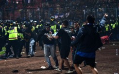 Tragedy: A fan is carried off the pitch 