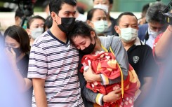 One mother wept inconsolably, hugging her dead son's favourite red-and-yellow blanket and his milk bottle, still half-full