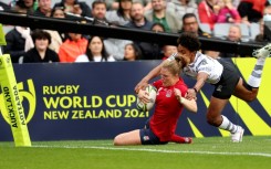 England's Lydia Thompson scores a try against Fiji