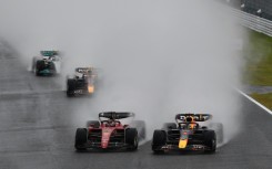 Red Bull Racing's Dutch driver Max Verstappen (R) and Ferrari's Monegasque driver Charles Leclerc (C) take the first turn at the start of the Formula One Japanese Grand Prix at Suzuka, Mie prefecture on October 9, 2022.