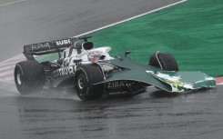 Pierre Gasly collected a damaged advertising board on the front of his car at Suzuka on a chaotic first lap