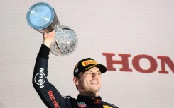 Red Bull Racing's Dutch driver Max Verstappen poses on the podium with the trophy following his victory at the Formula One Japanese Grand Prix at Suzuka, Mie prefecture on October 9, 2022.