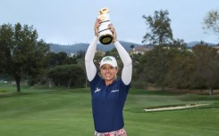 England's Jodi Ewart Shadoff hoists the champion's trophy after capturing her first LPGA title at the Mediheal Championship