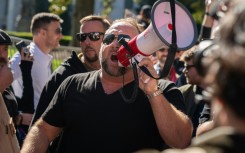 Alex Jones, at a November 2020 rally in Atlanta, Georgia, has been found liable in multiple defamation lawsuits brought by relatives of the victims of the Sandy Hook shooting