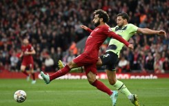 Liverpool match-winner Mohamed Salah (L) is challenged by Manchester City defender Ruben Dias.
