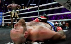 Former world heavyweight champion Deontay Wilder, left, poses moments after knocking out Finland's Robert Helenius, front, in the first round of their fight in New York