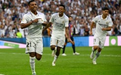 Real Madrid's Brazilian forward Rodrygo (L) celebrates after scoring his team's third goal against Barca