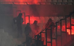 French riot police move in after flares were set off during the UEFA Champions League match between Marseille and Eintracht Frankfurt at Stade Velodrome 