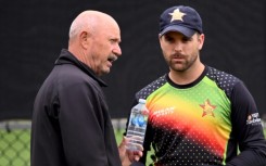 Zimbabwe coach Dave Houghton (L) talks with player Ryan Burl