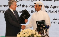 Qatar's Minister of State for Energy Affairs and President and CEO of QatarEnergy Saad Sherida al-Kaabi (R) and Shell’s CEO Ben van Beurden hold a signing ceremony at QatarEnergy headquarters in Doha, on October 23