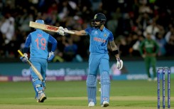 India's Virat Kohli celebrates reaching his half-century