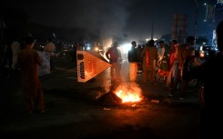 Khan's supporters lit fires and staged protests in Karachi, and other cities, after hearing he had been shot