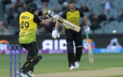 Australia's Steve Smith (L) plays a shot against Afghanistan