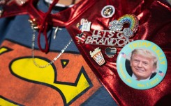 A supporter wears pins supporting former US president Donald Trump while arriving at a rally in Vandalia, Ohio, on November 7, 2022 -- the eve of US midterm elections