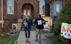 I voted -- Joyce Matthews, left, gets help walking back to her vehicle from Teaira Collins, a volunteer, after voting in Pittsburgh, Pennsylvania