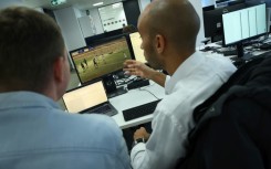 Tom Mace (left) with an analsyst responding to alerts on the company's betting patterns detection system 