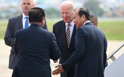 US President Joe Biden (C) is greeted by Cambodian officials after arriving in Phnom Penh on Saturday for an ASEAN summit