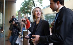 Former Theranos CEO Elizabeth Holmes arrives at court with her partner Billy Evans in October 2022 in San Jose, California
