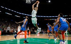 Boston's Jayson Tatum goes in for a slam dunk over Oklahoma City's Kenrich Williams in the Celtics' 126-122 NBA victory