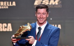 Barcelona's Polish forward Robert Lewandowski poses for pictures holding the Golden Boot trophy during the Golden Boot 2022 award ceremony