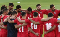 Iran's players gather in a huddle during a World Cup training session