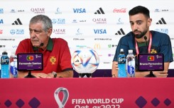 Portugal's coach Fernando Santos (L) and Portugal midfielder Bruno Fernandes hold a press conference